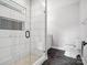 Sleek bathroom showcasing an enclosed glass shower, dark floors, and modern finishes at 913 Van Every St, Charlotte, NC 28205