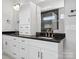 Bathroom with double vanity, dark countertop, white cabinets, and a modern shower at 913 Van Every St, Charlotte, NC 28205