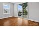 Comfortable bedroom featuring hardwood floors and a sliding glass door leading to the back deck at 913 Van Every St, Charlotte, NC 28205