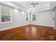 Spacious bedroom with hardwood floors, tray ceiling, and bright natural light at 913 Van Every St, Charlotte, NC 28205