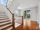 Elegant foyer with hardwood floors, a staircase, and access to an outdoor deck at 913 Van Every St, Charlotte, NC 28205