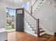 Home foyer featuring hardwood floors, staircase, and view through front door at 913 Van Every St, Charlotte, NC 28205