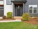 A close view of a modern home's front door with detailed trim, landscape and architectural elements at 913 Van Every St, Charlotte, NC 28205