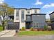 Contemporary two-story home showcasing modern design and landscaping with a garage and outdoor deck at 913 Van Every St, Charlotte, NC 28205