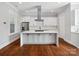 Gorgeous kitchen with waterfall island, stainless appliances, and custom cabinetry at 913 Van Every St, Charlotte, NC 28205