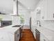 Open kitchen with large island, stainless hood, and herringbone backsplash at 913 Van Every St, Charlotte, NC 28205