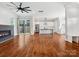 Open-concept living room showcasing hardwood floors, fireplace, kitchen, and access to outdoor space at 913 Van Every St, Charlotte, NC 28205