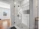 Bathroom showcasing a glass shower with white tiling, black fixtures, and a herringbone tile floor at 913 Van Every St, Charlotte, NC 28205