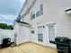 A view of the house back patio with a small shed and white fence surrounding it at 9615 Littleleaf Dr, Charlotte, NC 28215