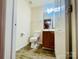 Cozy bathroom with wood vanity, mirror, light fixture, and tile flooring at 9615 Littleleaf Dr, Charlotte, NC 28215