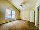 Bedroom with a ceiling fan, carpet flooring, neutral paint, and natural light at 9615 Littleleaf Dr, Charlotte, NC 28215
