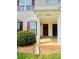 Inviting townhouse entrance featuring classic columns and manicured bushes at 9615 Littleleaf Dr, Charlotte, NC 28215