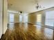 Open living area with wood-look floors, ceiling fan, and sliding glass doors leading to patio at 9615 Littleleaf Dr, Charlotte, NC 28215