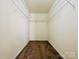 Walk-in closet offers ample storage with wire shelving and carpet floors at 9615 Littleleaf Dr, Charlotte, NC 28215