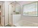 Clean bathroom featuring a shower, a tub, and a bright window at 9727 White Chapel Nw Dr, Concord, NC 28027