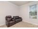 Neutral bedroom with a comfortable seating area and natural light at 9727 White Chapel Nw Dr, Concord, NC 28027