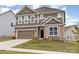 Well-maintained two-story home with brown siding, stone accents, a two-car garage and nice landscaping at 9727 White Chapel Nw Dr, Concord, NC 28027