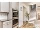 Modern kitchen featuring stainless steel appliances and a staircase at 9727 White Chapel Nw Dr, Concord, NC 28027
