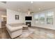 Bright living room boasts a cozy fireplace, plush seating, and plenty of natural light at 9727 White Chapel Nw Dr, Concord, NC 28027