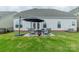 Backyard features a patio with an umbrella and seating with a fire pit at 1005 Argentium Way, Waxhaw, NC 28173