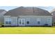 Backyard view featuring a patio, lawn, and double doors at 1005 Argentium Way, Waxhaw, NC 28173