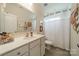 Bright bathroom with neutral colors, vanity, and walk-in shower at 1005 Argentium Way, Waxhaw, NC 28173