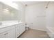 Bathroom featuring a shower, natural light, double vanity sinks, and tiled floors at 1005 Argentium Way, Waxhaw, NC 28173