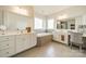 This bathroom features dual sinks and vanities and a soaking tub below a window at 1005 Argentium Way, Waxhaw, NC 28173