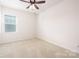 Bedroom with a ceiling fan, carpet flooring, and bright window at 1005 Argentium Way, Waxhaw, NC 28173