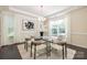 Bright dining room showcasing a modern chandelier and a large window with bright natural light at 1005 Argentium Way, Waxhaw, NC 28173