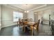 Bright dining room with traditional wood table and chairs, window view, and elegant chandelier at 1005 Argentium Way, Waxhaw, NC 28173
