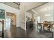 Open-concept dining room with dark wood floors, a wooden table, and views to other living spaces at 1005 Argentium Way, Waxhaw, NC 28173