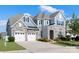 Impressive two-story home boasting a stone and siding facade, complemented by a two-car garage and manicured lawn at 1005 Argentium Way, Waxhaw, NC 28173