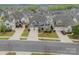 An aerial view of the home showcases stone accents, a three-car garage, and mature landscaping at 1005 Argentium Way, Waxhaw, NC 28173