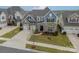 Charming two-story home featuring stone accents, a well-manicured lawn, and an attached two-car garage at 1005 Argentium Way, Waxhaw, NC 28173