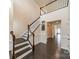 Spacious foyer with dark wood floors, a staircase, and a view into the hallway at 1005 Argentium Way, Waxhaw, NC 28173