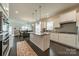 Bright kitchen with granite countertops, stainless appliances, island and views to the living area at 1005 Argentium Way, Waxhaw, NC 28173