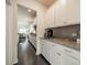 Kitchen with white cabinetry, granite countertops, gray subway tile backsplash, and hardwood floors at 1005 Argentium Way, Waxhaw, NC 28173