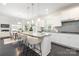 Bright kitchen featuring granite counters, an island with seating, and stainless steel appliances at 1005 Argentium Way, Waxhaw, NC 28173