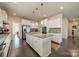 Bright kitchen with center island, granite countertops, stainless appliances, and hardwood floors at 1005 Argentium Way, Waxhaw, NC 28173