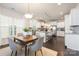 Open concept kitchen showcasing granite counters, white cabinets, and a dining area at 1005 Argentium Way, Waxhaw, NC 28173
