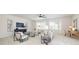 Open living room with lots of windows, neutral colors, and a ceiling fan at 1005 Argentium Way, Waxhaw, NC 28173