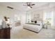 Bright main bedroom featuring a king bed, neutral color palette, and bathroom entrance at 1005 Argentium Way, Waxhaw, NC 28173