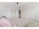 Bright bedroom featuring neutral walls, carpet flooring, a ceiling fan, and a closet with white doors at 10072 Fox Trotter Ln, Midland, NC 28107