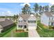Charming two-story home with a manicured lawn and inviting front porch seating, and a two car garage at 10072 Fox Trotter Ln, Midland, NC 28107