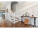 Spacious hallway features hardwood floors, wainscoting accents, and a staircase leading to the upper level at 10072 Fox Trotter Ln, Midland, NC 28107