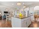 Open-concept kitchen with granite island, pendant lighting, and stainless steel appliances for stylish cooking at 10072 Fox Trotter Ln, Midland, NC 28107
