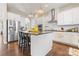 Bright kitchen featuring stainless refrigerator, island with seating, and subway tile at 10072 Fox Trotter Ln, Midland, NC 28107