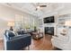 Bright living room boasts a fireplace, coffered ceilings, and hardwood floors at 10072 Fox Trotter Ln, Midland, NC 28107