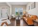 Bright living room featuring hardwood floors, modern furniture, and large windows offering plenty of natural light at 10072 Fox Trotter Ln, Midland, NC 28107